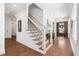 Bright foyer with hardwood floors, a staircase with dark iron balusters, and natural light at 144 Arabella Ct, Cary, NC 27518
