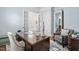 Spacious home office featuring double doors, a writing desk, and a comfortable accent chair at 144 Arabella Ct, Cary, NC 27518
