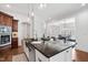 Open kitchen showcasing large island with stainless steel sink and granite countertops at 144 Arabella Ct, Cary, NC 27518