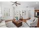 Bright living room with custom built-ins, plantation shutters, and hardwood floors at 144 Arabella Ct, Cary, NC 27518