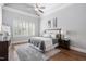 Serene bedroom features plantation shutters, neutral colors, and plush rug at 144 Arabella Ct, Cary, NC 27518