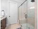 Beautiful walk-in shower with stone pebble floor and seating area at 144 Arabella Ct, Cary, NC 27518