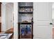 Built-in wet bar with beverage fridge, wine storage, and marble countertop at 144 Arabella Ct, Cary, NC 27518