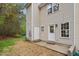 Back exterior of home with two doors leading to backyard and light tan siding at 1620 Briarmont Ct, Raleigh, NC 27610