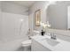 All white bathroom with a shower and tub combination and a vanity with a white countertop at 1620 Briarmont Ct, Raleigh, NC 27610