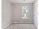 Bright bedroom featuring a window, neutral carpet, and a closet for optimal storage at 1620 Briarmont Ct, Raleigh, NC 27610