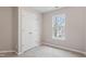 Neutral bedroom with carpet, a closet, and a window with a view of the trees at 1620 Briarmont Ct, Raleigh, NC 27610