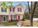Charming townhome featuring red shutters, complemented by lush landscaping, offers inviting curb appeal at 1620 Briarmont Ct, Raleigh, NC 27610