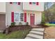 Inviting front entrance with red shutters and door, complemented by tasteful landscaping and a welcoming pathway at 1620 Briarmont Ct, Raleigh, NC 27610
