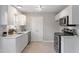 Bright kitchen features white cabinets, stainless steel appliances, and modern countertops at 1620 Briarmont Ct, Raleigh, NC 27610