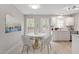 Eat-in kitchen with stainless appliances, marble countertop and backsplash, plus view to backyard at 1620 Briarmont Ct, Raleigh, NC 27610