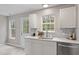 Bright kitchen with stainless appliances, marble countertop and backsplash, plus view to backyard at 1620 Briarmont Ct, Raleigh, NC 27610