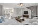 Bright living room flows into the kitchen and features hardwood floors at 1620 Briarmont Ct, Raleigh, NC 27610