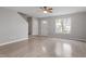 Open-concept living room with wood-look flooring, a ceiling fan, and natural light from a large window at 1620 Briarmont Ct, Raleigh, NC 27610