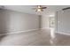 Spacious living room with wood-look flooring, base molding, neutral paint, and a bright window at 1620 Briarmont Ct, Raleigh, NC 27610