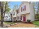 A row of townhomes showcases their curb appeal and well-manicured lawns in a friendly neighborhood setting at 1620 Briarmont Ct, Raleigh, NC 27610
