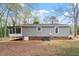The rear exterior showcases a screened-in porch, gray siding, and an AC unit at 206 Woods Run, Knightdale, NC 27545
