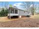 The rear exterior showcases a screened-in porch, gray siding, and an AC unit at 206 Woods Run, Knightdale, NC 27545