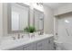 Bright bathroom featuring double sinks, framed mirrors, modern fixtures, and a shower-tub combination at 206 Woods Run, Knightdale, NC 27545