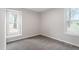 Cozy bedroom with two windows offering natural light and plush neutral carpeting at 206 Woods Run, Knightdale, NC 27545