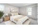 Serene bedroom with soft lighting, neutral colors, and a cozy bed with a patterned rug at 206 Woods Run, Knightdale, NC 27545