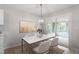 Elegant dining area with a modern chandelier, a light table and chairs, and sliding door access to sun room at 206 Woods Run, Knightdale, NC 27545