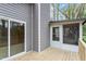Exterior corner view featuring gray siding, a screened-in porch and glass sliding doors at 206 Woods Run, Knightdale, NC 27545