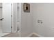 Hallway with wood floors and a utility box, with access to bathroom at 206 Woods Run, Knightdale, NC 27545