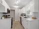 Updated kitchen featuring white cabinets, stainless steel appliances, and modern fixtures at 206 Woods Run, Knightdale, NC 27545