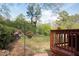 Cozy backyard deck with hanging flower baskets and wooded area at 2061 Carriage Way, Chapel Hill, NC 27517