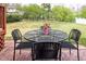 Inviting backyard patio with stylish outdoor seating and a well-maintained lawn at 2061 Carriage Way, Chapel Hill, NC 27517
