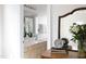 Bathroom with double vanity, large mirror, and a glimpse into an adjacent bedroom at 2061 Carriage Way, Chapel Hill, NC 27517