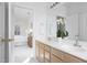 Bathroom with double vanity, large mirror, and an open doorway into the bedroom at 2061 Carriage Way, Chapel Hill, NC 27517
