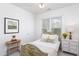 Light and airy bedroom features a bed, nightstand, and decor at 2061 Carriage Way, Chapel Hill, NC 27517