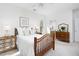 Bright bedroom with wooden furniture, plush bedding, and natural light from the window at 2061 Carriage Way, Chapel Hill, NC 27517