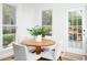 Charming breakfast nook with windows and a round table with chairs, perfect for casual dining at 2061 Carriage Way, Chapel Hill, NC 27517