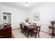 Traditional dining room with wood table, elegant wainscoting, neutral rug, and decorative chandelier at 2061 Carriage Way, Chapel Hill, NC 27517