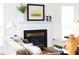 Close-up of the living room fireplace mantel with artwork and decor at 2061 Carriage Way, Chapel Hill, NC 27517