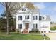 Beautiful two-story home with a well-manicured lawn and classic architectural details at 2061 Carriage Way, Chapel Hill, NC 27517