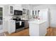 Modern kitchen featuring white cabinets, stainless steel appliances, and a functional island at 2061 Carriage Way, Chapel Hill, NC 27517