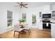 Cozy breakfast nook and bright kitchen area with white cabinets and appliances, and hardwood floors at 2061 Carriage Way, Chapel Hill, NC 27517