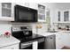 Stylish kitchen with stainless steel appliances, white cabinets, and ample counter space at 2061 Carriage Way, Chapel Hill, NC 27517