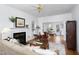 Open living area with hardwood floors, fireplace, access to kitchen, and bright dining area at 2061 Carriage Way, Chapel Hill, NC 27517