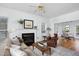 Bright living room featuring a fireplace, hardwood floors, comfortable seating, and open access to dining area at 2061 Carriage Way, Chapel Hill, NC 27517