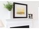 Close-up of decorative mantel with decorative painting, greenery, and candles at 2061 Carriage Way, Chapel Hill, NC 27517