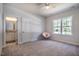 Bright bedroom featuring neutral carpet, fan, and a window offering pleasant outside views at 2075 Toad Hollow Trl, Apex, NC 27502