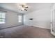Spacious bedroom featuring neutral carpet, large windows, and a TV mount at 2075 Toad Hollow Trl, Apex, NC 27502