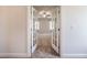 A bedroom view through the French doors, with neutral carpet and a ceiling fan at 2075 Toad Hollow Trl, Apex, NC 27502