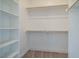 A bright walk-in closet with shelves and hanging rods at 2075 Toad Hollow Trl, Apex, NC 27502