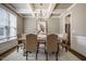 Stylish dining room with a coffered ceiling, chandelier, and comfortable seating for six at 2075 Toad Hollow Trl, Apex, NC 27502